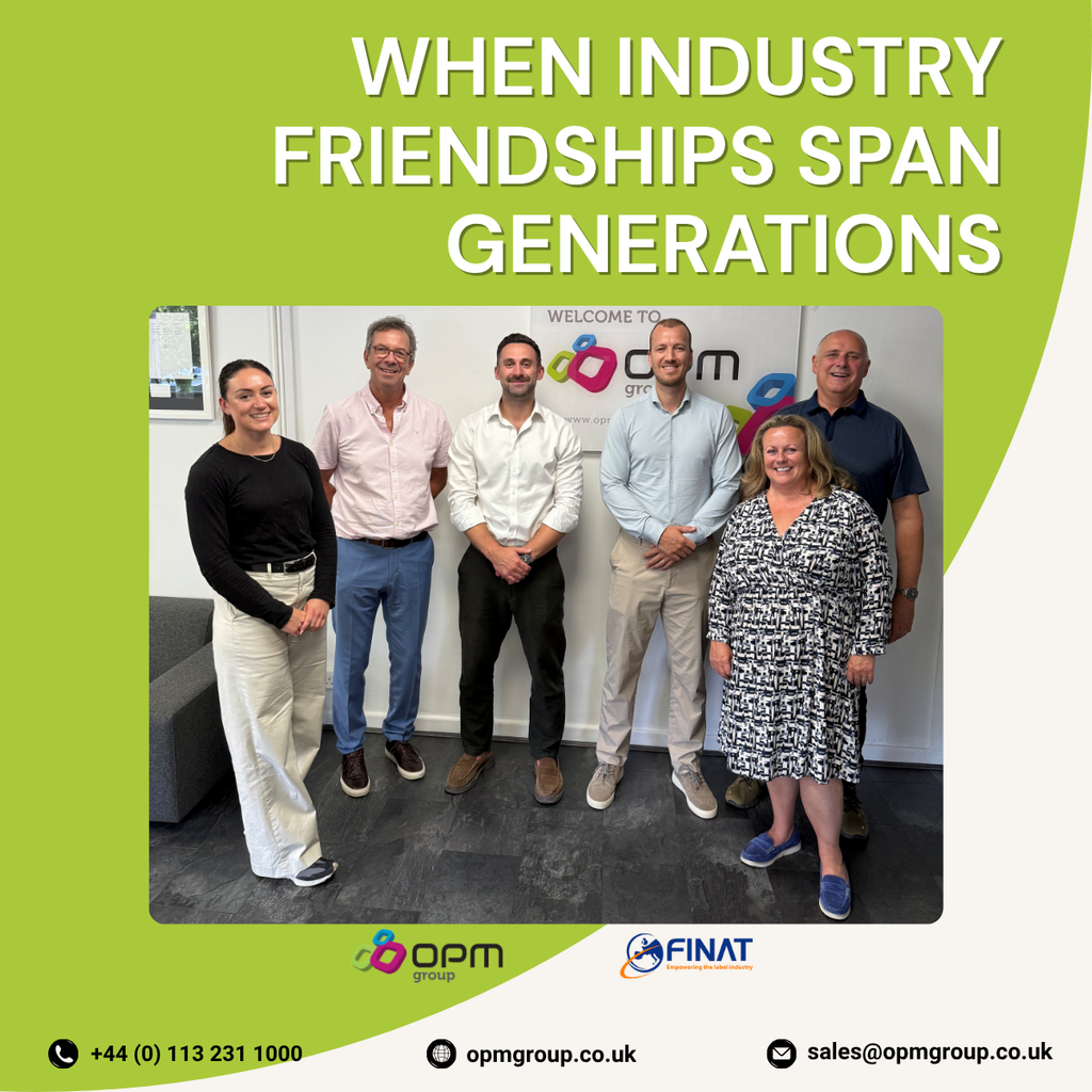 A green and white graphic with a central photograph showing Jules and Luc Lejeune from FINAT alongside Chris, Susan, Charlotte and Arnie Ellison from OPM Group standing together in OPM Group's Leeds reception area. The graphic includes the headline 'When Industry Friendships Span Generations' alongside the OPM Group and FINAT logos The visit celebrated industry collaboration, family business values and relationships that have developed over many years within the label and packaging industry.